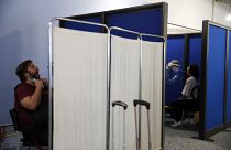 Medical staff conduct a test for the new coronavirus on the passengers who arrived from Doha, Qatar to the Eleftherios Venizelos International Airport in Athens, Monday, June