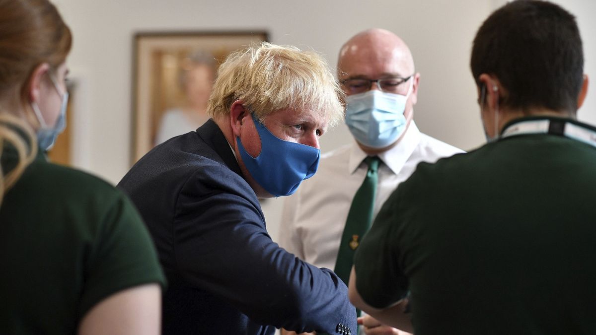British prime minister Boris Johnson wears a mask while visiting the HQ of the London Ambulance Service.