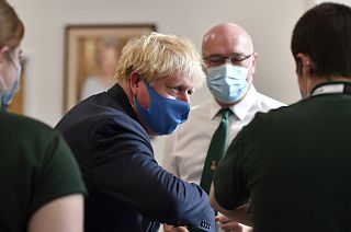 British prime minister Boris Johnson wears a mask while visiting the HQ of the London Ambulance Service.