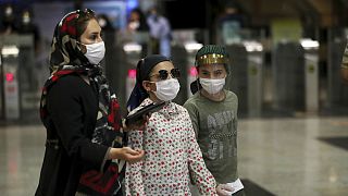 People wearing protective face masks to help prevent the spread of the coronavirus walk in a metro station, in Tehran, Iran