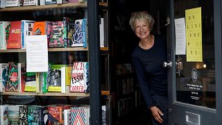 Jane Howe, owner of the Broadway Bookshop, poses for a photo in the doorway of her shop on Broadway Market in Hackney, east London on June 28, 2020 