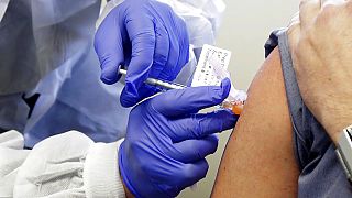 A subject receives a shot in the first-stage safety study clinical trial of a potential vaccine by Moderna for COVID-19