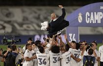 Real Madrid players throw head coach Zinedine Zidane in the air as they celebrate after winning the La Liga title.