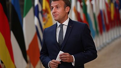 French President Emmanuel Macron makes a statement as he arrives for an EU summit at the European Council building in Brussels, Friday, July 17, 2020.