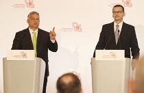Hungarian Prime Minister Viktor Orban,left, speaks at a join news conference with Poland's Prime Minister Mateusz Morawiecki,right, Jul 3 2020