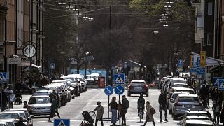 People walk on the streets, amid the coronavirus outbreak, in central Stockholm in April 2020. 