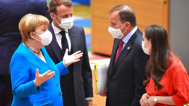German Chancellor Angela Merkel and French President Emmanuel Macron speak with Sweden's Prime Minister Stefan Lofven and Finland's Prime Minister Sanna Marin German Chancellor Angela Merkel and French President Emmanuel Macron speak with Sweden's Prime Minister Stefan Lofven and Finland's Prime Minister Sanna Marin