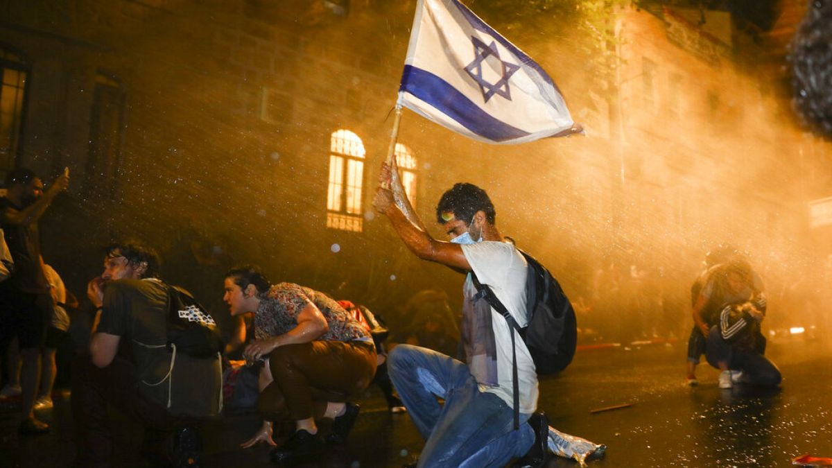 Israeli police use a water cannon to disperse people during a protest against Israeli Prime Minister Benjamin Netanyahu in Jerusalem, Saturday, July 18, 2020
