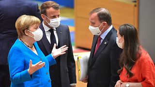 German Chancellor Angela Merkel, left, and French President Emmanuel Macron, second left, speak with Sweden's Prime Minister Stefan Lofven, second right, and Finland's Prime M