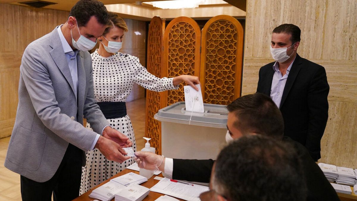 Syrian President Bashar Assad and his wife Asma vote at a polling station in the parliamentary elections in Damascus, Syria