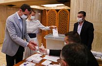 Syrian President Bashar Assad and his wife Asma vote at a polling station in the parliamentary elections in Damascus, Syria