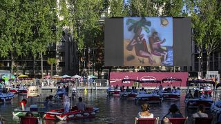 People on boats attend the "Le Cinema Sur L'Eau", or Cinema on the Water, organized by Paris Plages.