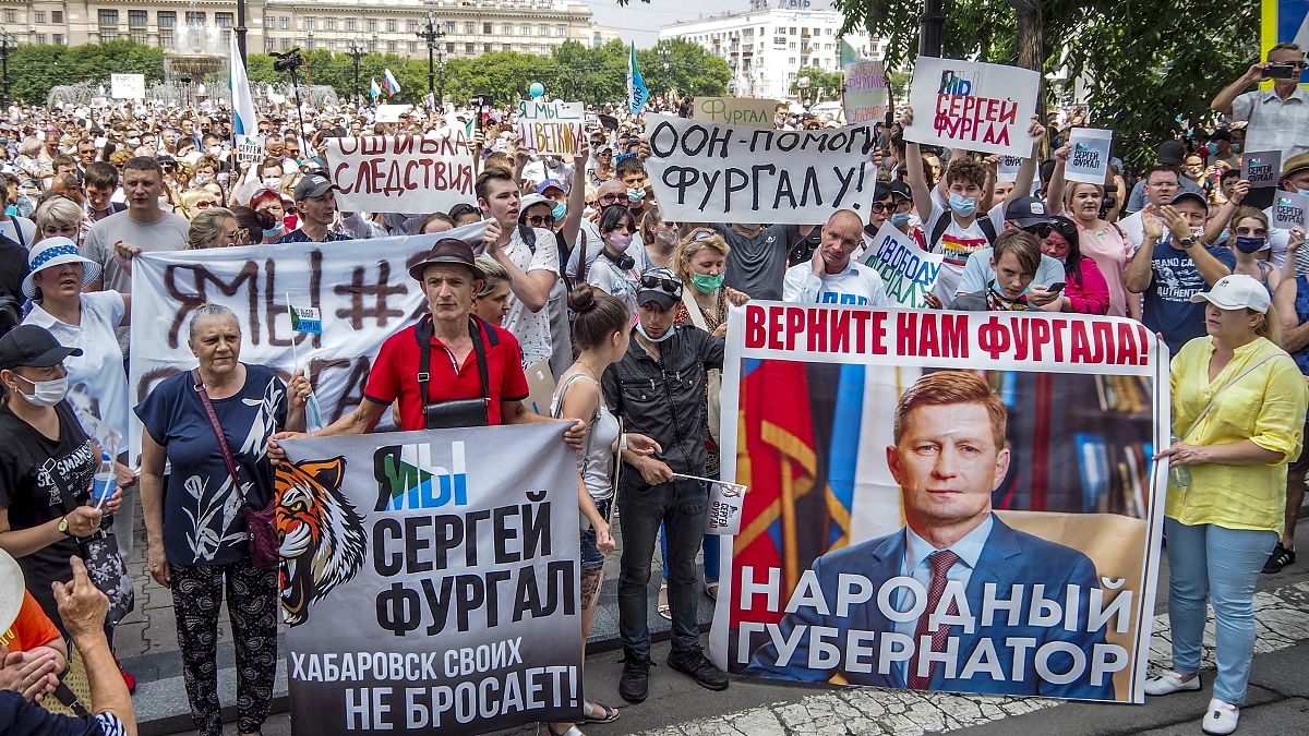 Demonstranten in Chabarowsk, Russland, halten Schilder hoch, auf denen zu lesen ist: "Freiheit für Sergej Furgal, ich bin, wir sind Sergej Furgal".