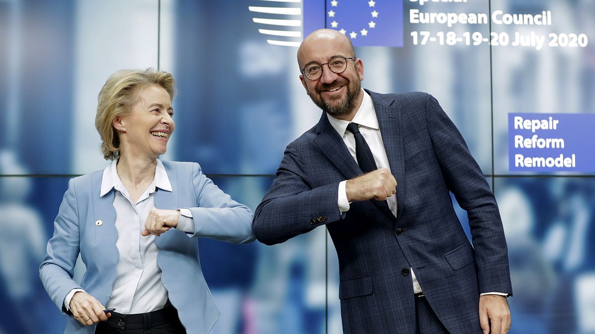 European Commission President Ursula von der Leyen, left, and European Council President Charles Michel bump elbows after addressing a media conference at an EU summit.