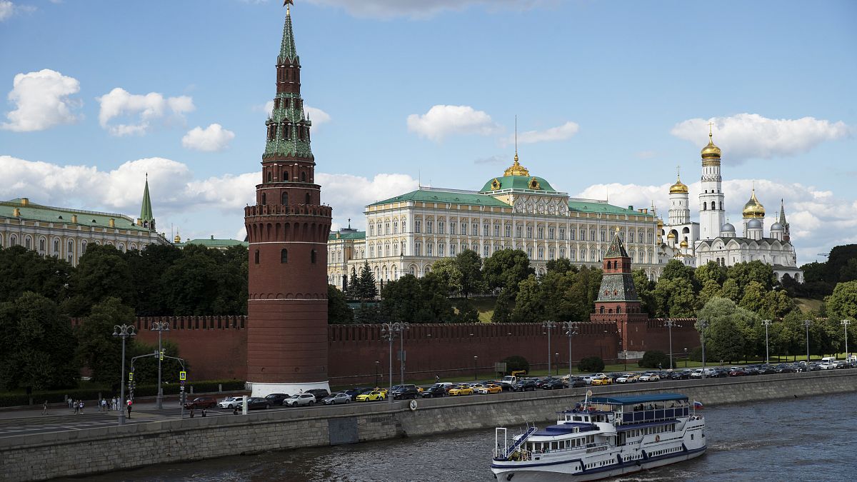 A tourist boat passes the Kremlin in Moscow, Russia, Friday, July 10, 2020