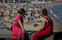 Two women look at the beach in Barcelona, Spain