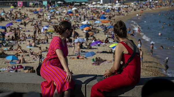 Two women look at the beach in Barcelona, Spain Two women look at the beach in Barcelona, Spain