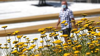 A man wearing a face mask to protect against coronavirus walks in downtown Belgrade, Serbia.