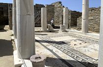 An Archaeological Service worker walks past marble columns on the island of Delos, an ancient center of religious and commercial life, in Greece, June 2020.