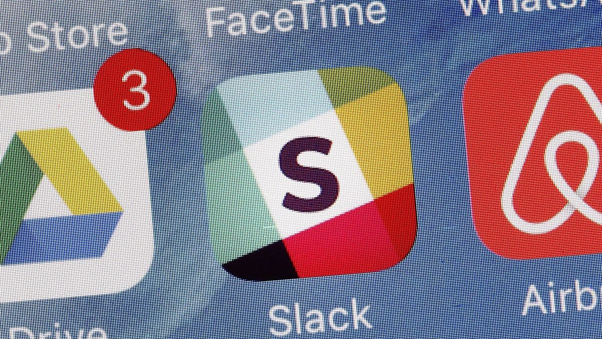 The Slack app is displayed on a mobile phone.