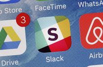 The Slack app is displayed on a mobile phone.