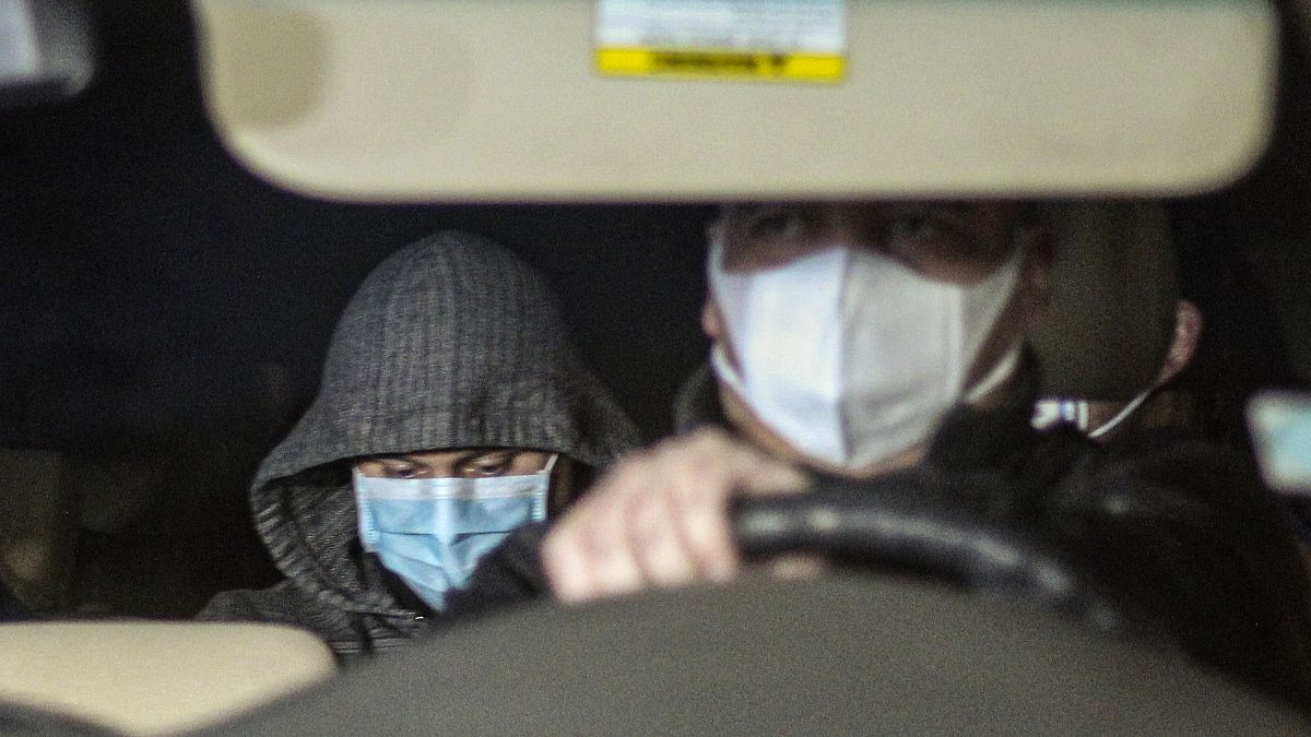 Nicolas Zepeda, centre right, is driven in a car by police investigators from his home, where he was under house arrest, one day prior his extradition to France.