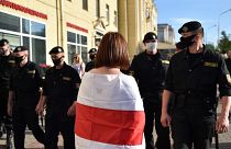Belarus' riot police officers watch opposition supporters in Minsk on June 19, 2020.