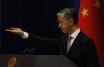 Foreign Ministry spokesperson Wang Wenbin gestures for questions during a daily briefing in Beijing.