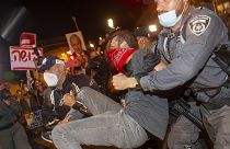 Israeli police officers arrest a demonstrator during a protest against prime minister Benjamin Netanyahu