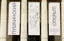 Banners at front of museum reading (Russian): "Pushkin (museum) Open"