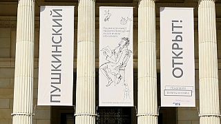 Banners at front of museum reading (Russian): "Pushkin (museum) Open"