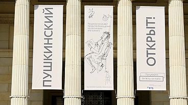 Banners at front of museum reading (Russian): "Pushkin (museum) Open"