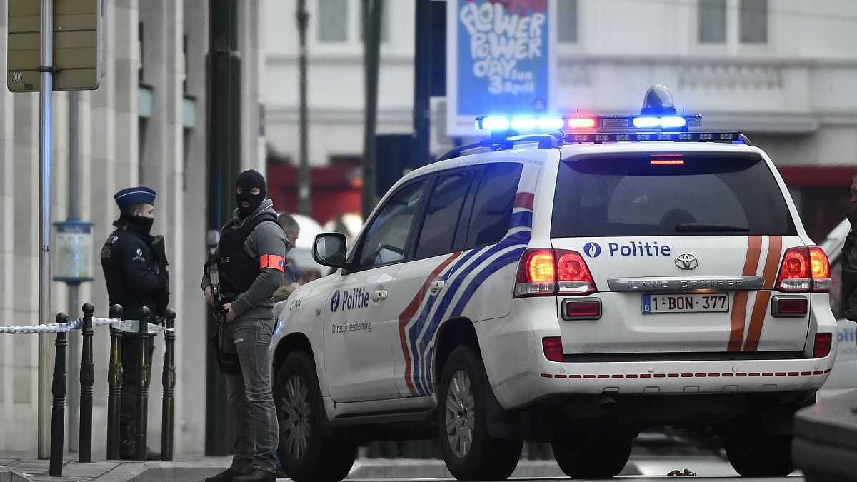 Police patrol a street in Brussels outside a courtroom during a hearing of suspect terrorist Salah Abdeslam
