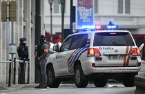 Police patrol a street in Brussels outside a courtroom during a hearing of suspect terrorist Salah Abdeslam