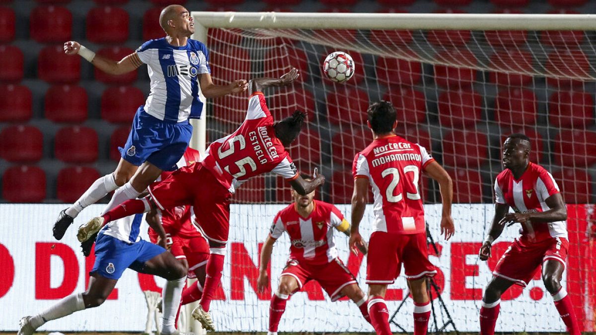 Porto's Pepe, left, jumps for the ball with Aves' Estrela during the Portuguese League soccer match between CD Aves and FC Porto in Vila das Aves.