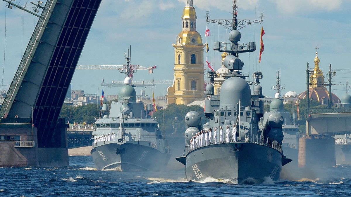 Russian warships sail on the Neva river during the Navy Day parade in Saint Petersburg.