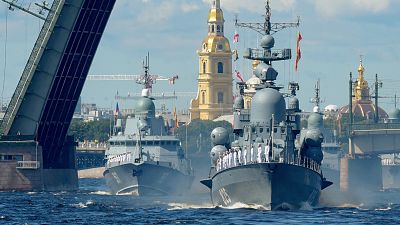Russian warships sail on the Neva river during the Navy Day parade in Saint Petersburg.