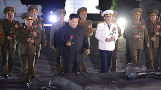 North Korean leader Kim Jong Un, center, with military officers in uniforms prepares to lay a flower to the Fatherland Liberation War Martyrs' Cemetery in Pyongyang.