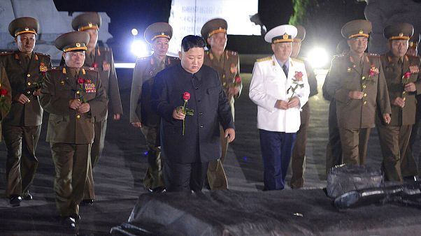 North Korean leader Kim Jong Un, center, with military officers in uniforms prepares to lay a flower to the Fatherland Liberation War Martyrs' Cemetery in Pyongyang. North Korean leader Kim Jong Un, center, with military officers in uniforms prepares to lay a flower to the Fatherland Liberation War Martyrs' Cemetery in Pyongyang.