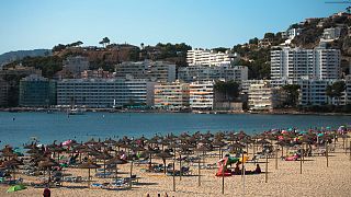  the beach in Palma de Mallorca, Spain, Sunday, July 26, 2020. Britain has put Spain back on its unsafe list and says travellers arriving in the UK from Spain must quarantine.