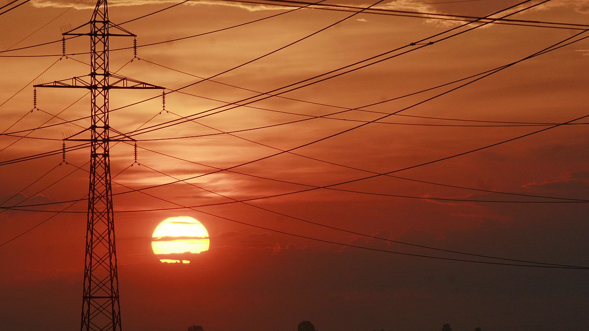 The sun sets behind power transmission lines near Kyiv, Ukraine.