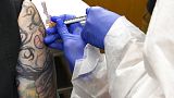 Nurse Kathe Olmstead, right, gives volunteer Melissa Harting, of Harpersville, N.Y., an injection as the world's biggest study of a possible COVID-19 vaccine on July 27, 2020