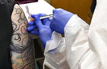 Nurse Kathe Olmstead, right, gives volunteer Melissa Harting, of Harpersville, N.Y., an injection as the world's biggest study of a possible COVID-19 vaccine on July 27, 2020
