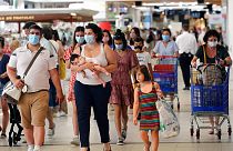 Customers wear face masks as they shop in a shopping mall in Anglet, southwestern France.