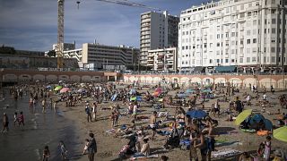 Beachgoers enjoy the sun at the Plage des Catalans in Marseille, southern France, July 25, 2020. 