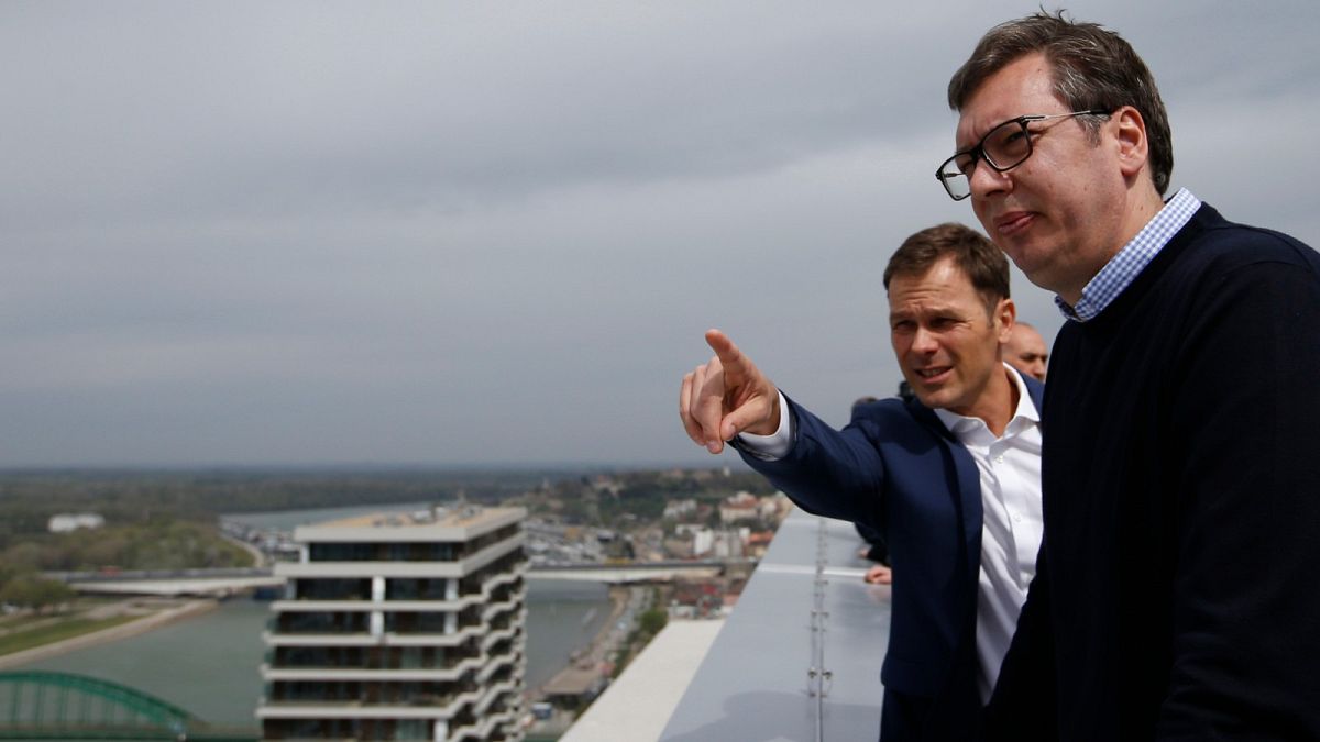 In this Friday, April 5, 2019, photo, Serbia's finance minister Sinisa Mali, left, speaks with Serbia's President Aleksandar Vucic in Belgrade, Serbia