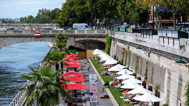 People enjoy the sun on deckchairs along the river Seine in Paris, Tuesday, July 28, 2020. People enjoy the sun on deckchairs along the river Seine in Paris, Tuesday, July 28, 2020.