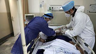 Medics tend to a COVID-19 patient at the Shohadaye Tajrish Hospital in Tehran, Iran