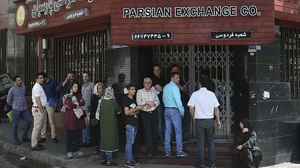 People line up in front of a currency exchange shop to buy U.S. dollars and euros, in downtown Tehran, Iran People line up in front of a currency exchange shop to buy U.S. dollars and euros, in downtown Tehran, Iran