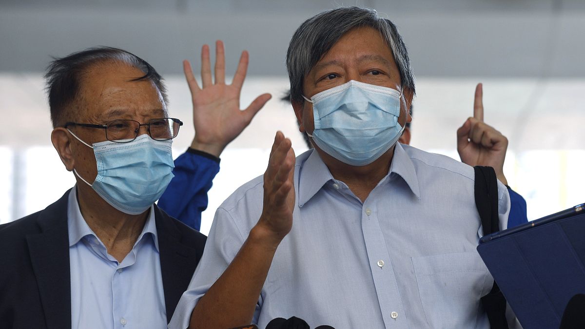 Pro-democracy activists Lee Cheuk-Yan, right, and Yeung Sum speak to media outside a district court in Hong Kong, Thursday, July 30, 2020.